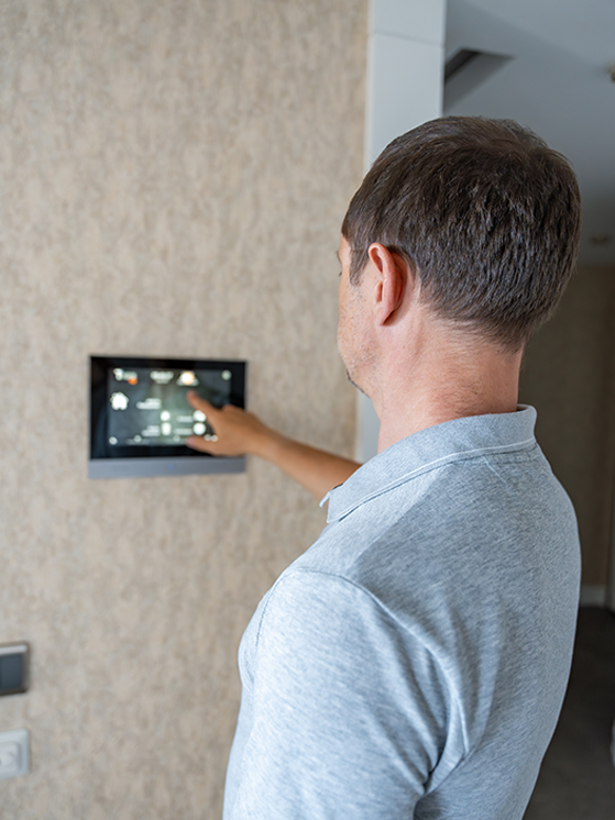 man-using-smart-thermostat-home-automation
